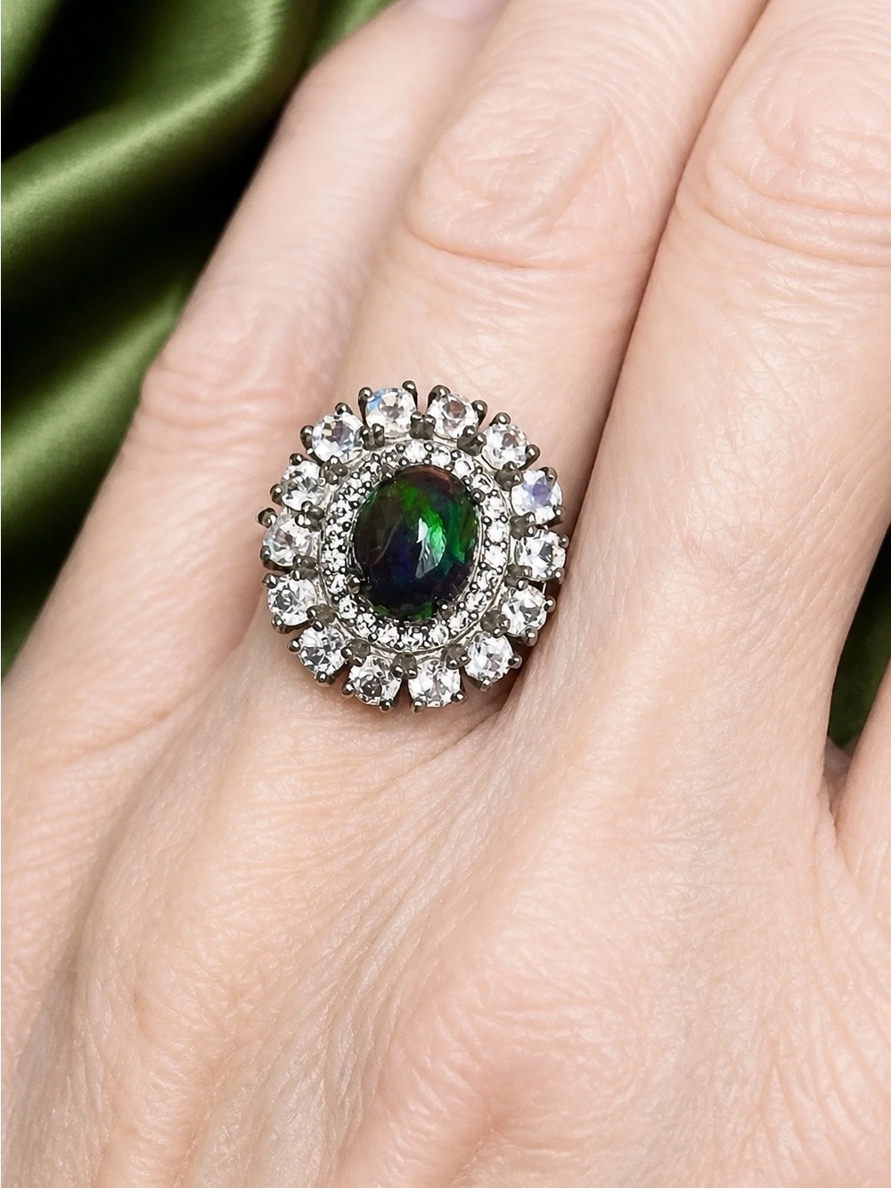 Gorgeous Black Opal Cabachon surrounded by white Topaz and 14-3mm moonstones